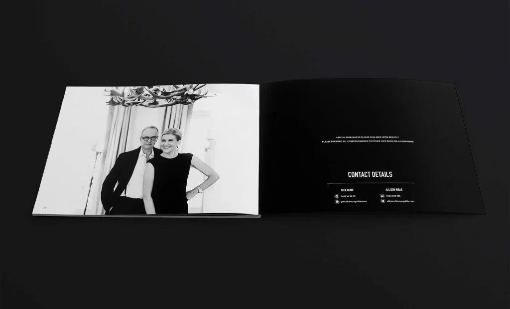An open booklet with a black-and-white photo of two smiling people on the left page and contact details on the right page.