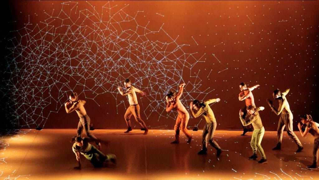 A group of dancers performing on a stage.