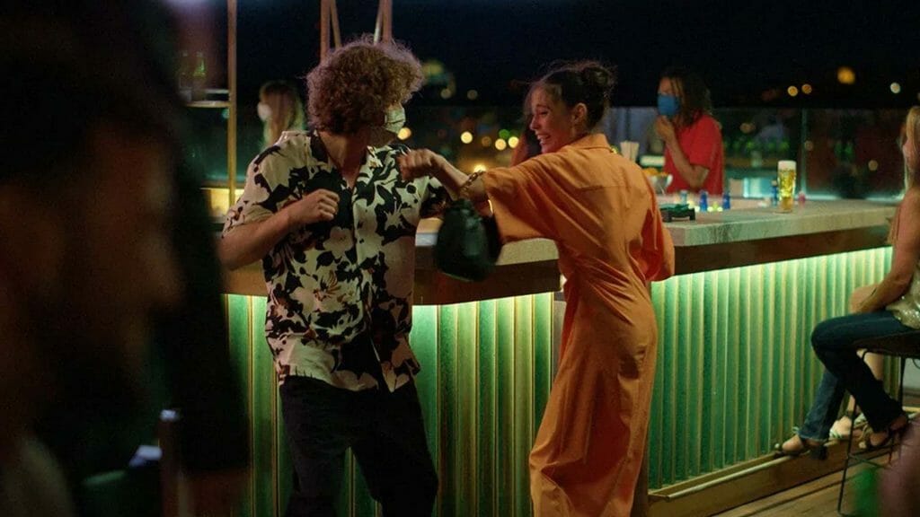 A man and a woman dancing at a bar.