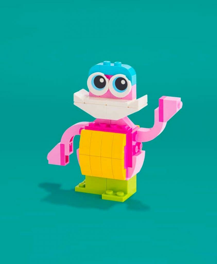 A lego toy with a pink and blue face.
