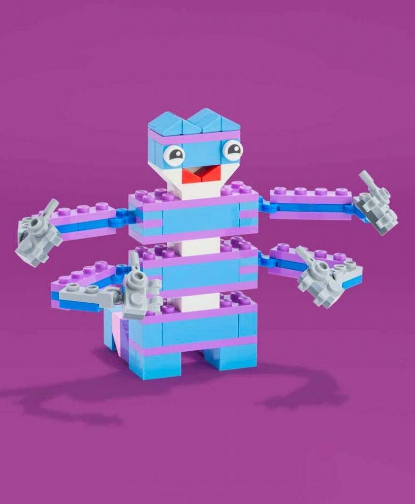 A blue and purple lego toy with two hands.