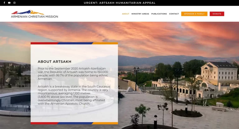 A webpage image for the Armenian Christian Mission featuring a humanitarian appeal banner and information about Artsakh overlaid on a scenic background of a town with sunset skies.